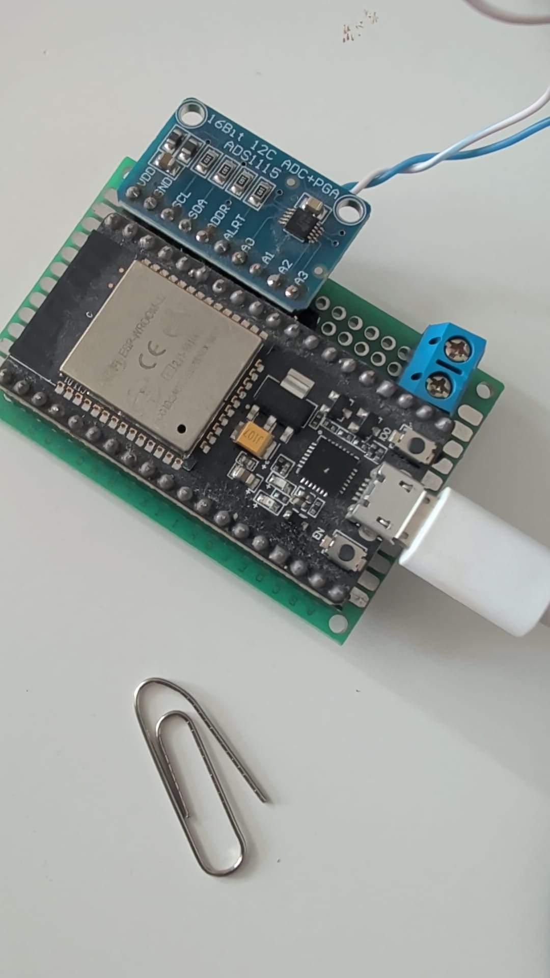 ESP32 with ADS1115 ADC and voltmeter on a breadboard.